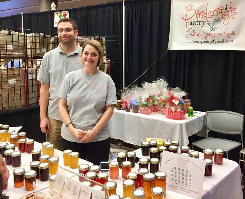 Patti D'Arbanville standing in front of a table