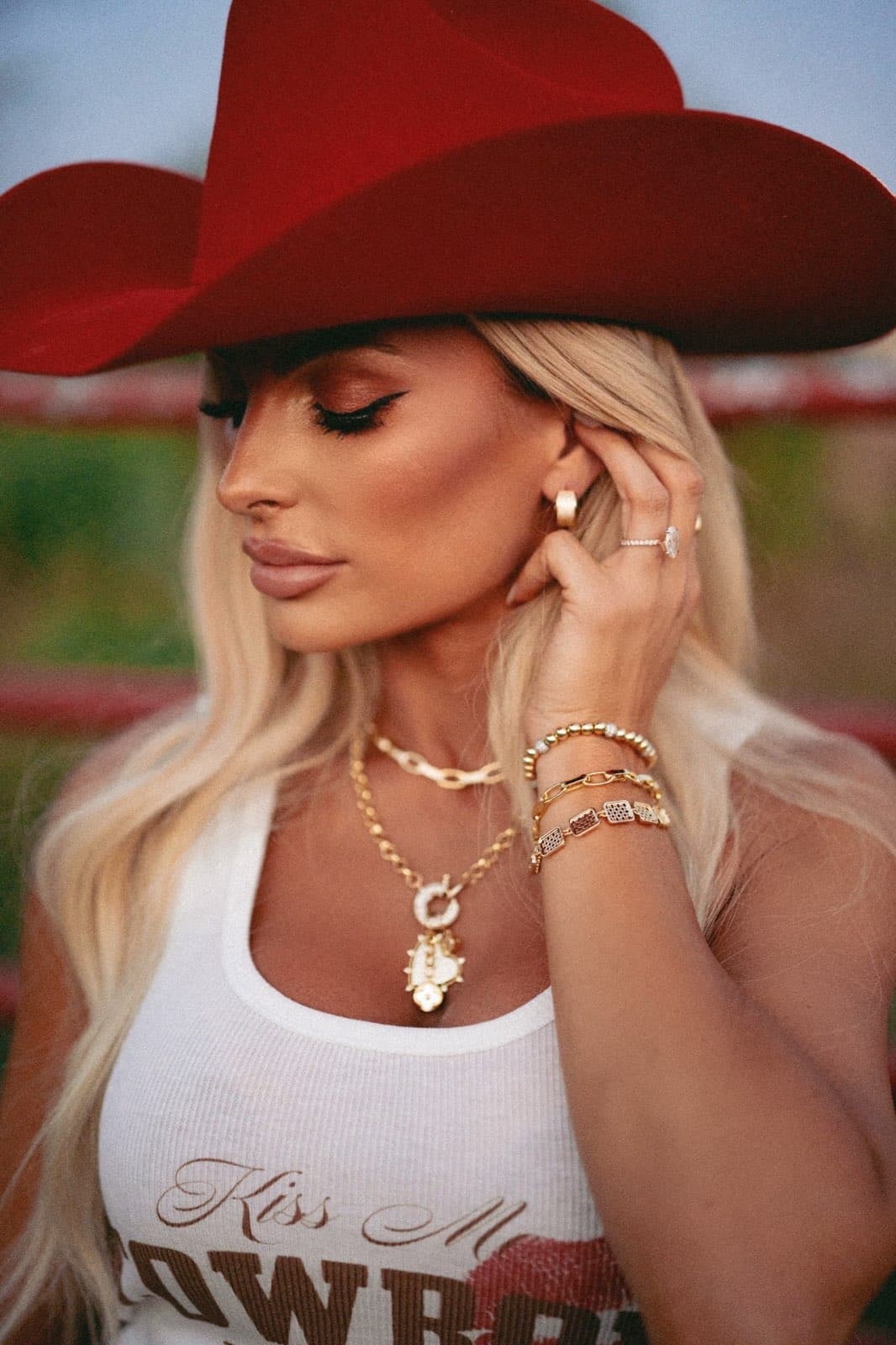 a woman wearing a hat talking on a cell phone